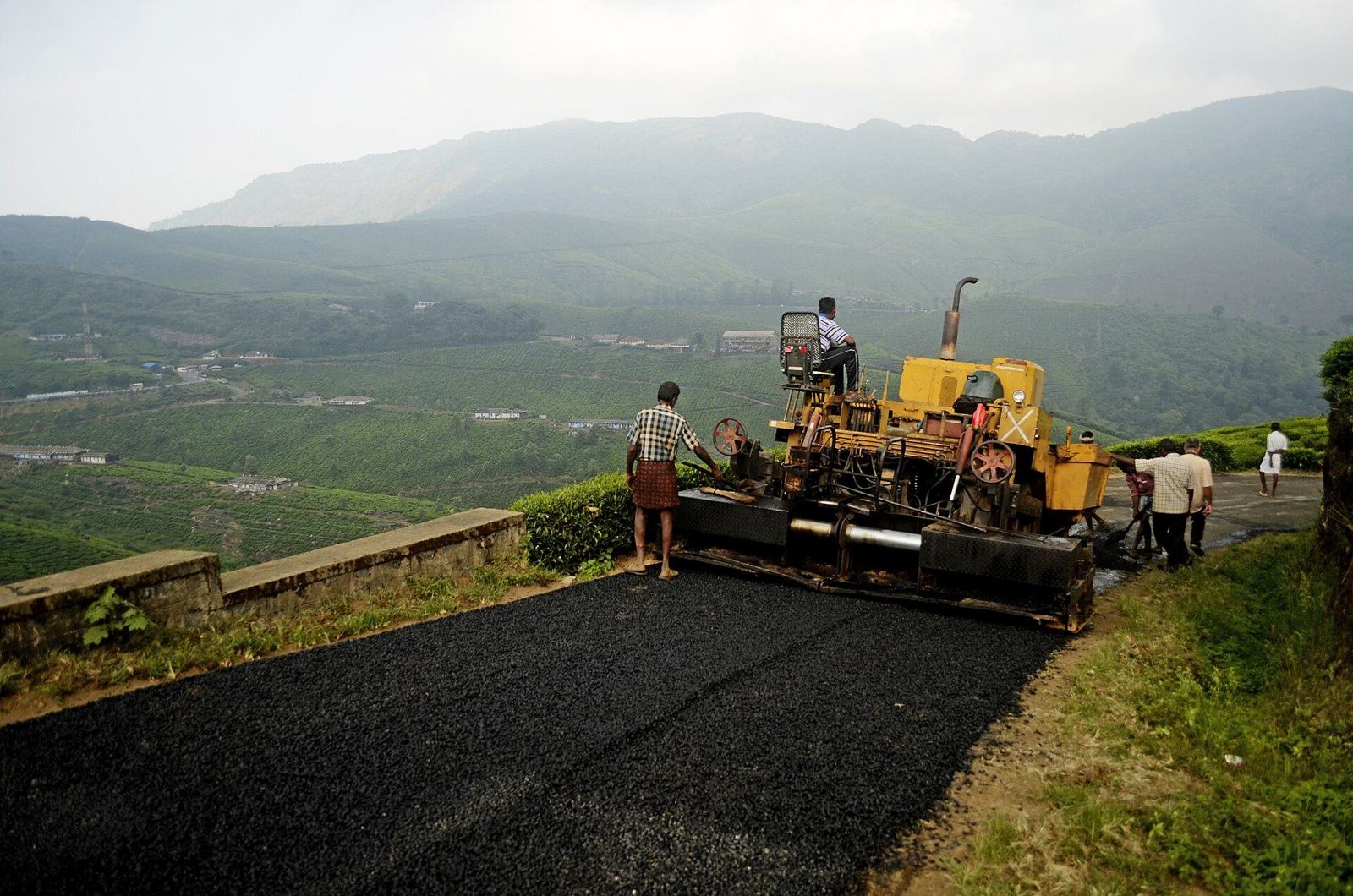Asphalt paver laying a new road in India